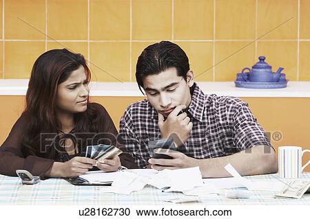 Stock Image - Close-up of a young couple thinking. Fotosearch