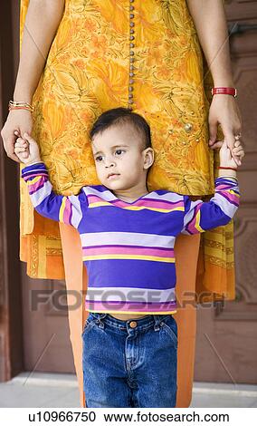 Girl standing and holding her mother's hands View Large Photo Image Stock Image - Girl standing and holding her mother's hands. Fotosearch