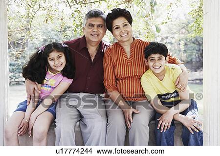 Picture - Grandparent sitting with their two grandchildren. Fotosearch