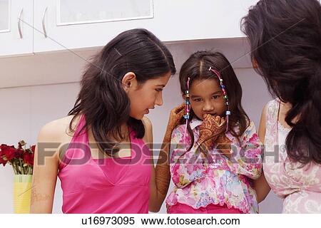 Mid adult woman with her daughter and young woman View Large Photo Image Stock Photography - Mid adult woman with her daughter and young woman. Fotosearch