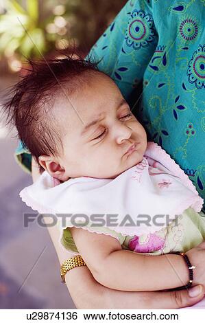 Mid section view of a woman carrying her daughter View Large Photo Image Stock Photograph - Mid section view of a woman carrying her daughter. Fotosearch
