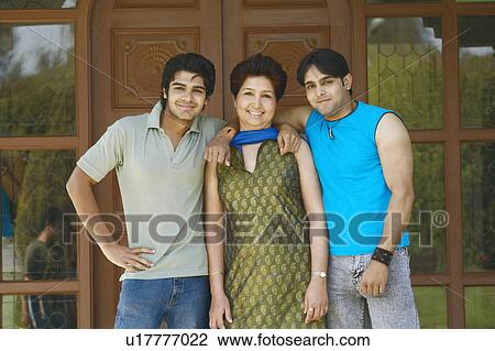 Portrait of a mature woman standing with her two sons View Large Photo Image Stock Image - Portrait of a mature woman standing with her two sons. Fotosearch