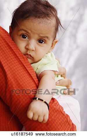 Stock Photo - Woman carrying her daughter. Fotosearch