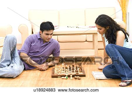 Young couple playing chess View Large Photo Image Stock Image - Young couple playing chess. Fotosearch