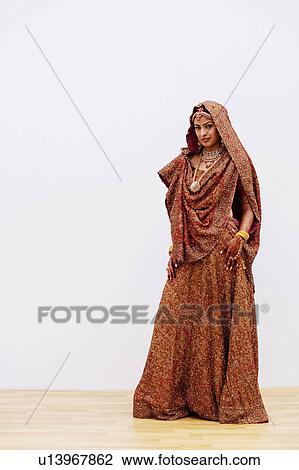 Stock Image - Portrait of a bride in a traditional wedding dress. Fotosearch