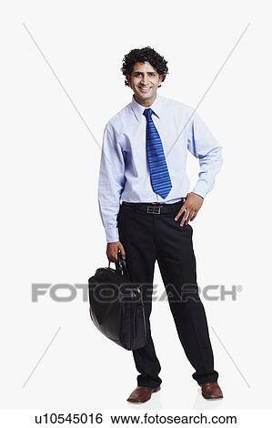 Portrait of a businessman holding a bag and smiling View Large Photo Image Stock Photograph - Portrait of a businessman holding a bag and smiling. Fotosearch