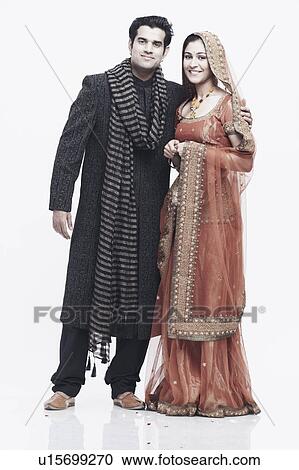 Portrait of a newlywed couple standing with their arms around each other View Large Photo Image Stock Image - Portrait of a newlywed couple standing with their arms around each other. Fotosearch