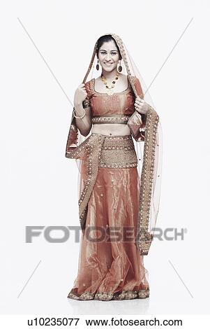 Portrait of a young woman in traditional clothing smiling View Large Photo Image Stock Photo - Portrait of a young woman in traditional clothing smiling. Fotosearch