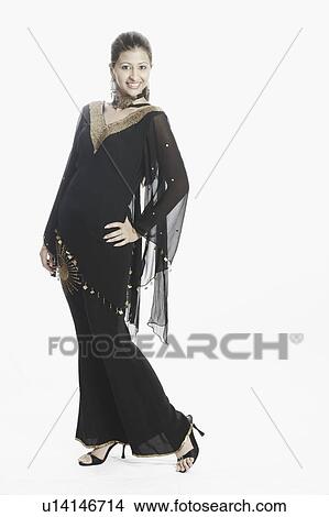 Picture - Portrait of a young woman with her hand on her hip smiling. Fotosearch