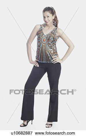 Stock Photo - Portrait of a young woman with her hands on her hips. Fotosearch