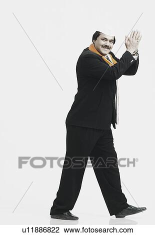 Side profile of a mature man clapping View Large Photo Image Stock Image - Side profile of a mature man clapping. Fotosearch