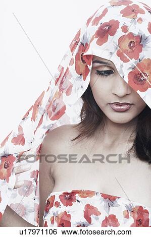 Stock Photograph - Close-up of a young woman covering her head with a stole. Fotosearch