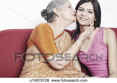 Stock Photo - Mother kissing her daughter. Fotosearch