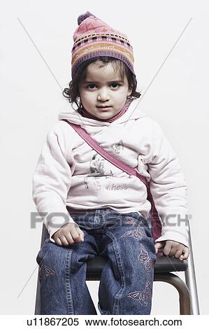 Stock Photography - Portrait of a girl wearing a bobble hat. Fotosearch