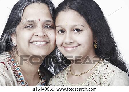 Stock Photography - Portrait of a mature woman and her daughter smiling. Fotosearch