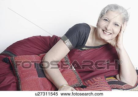 Stock Photography - Portrait of a mature woman lying down. Fotosearch