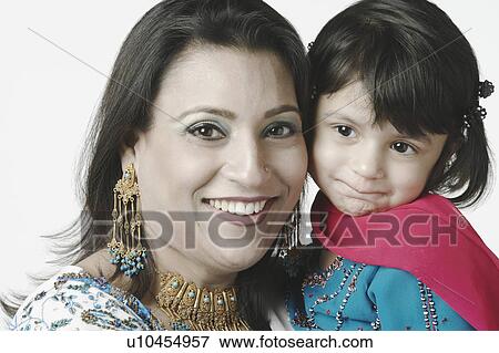 Stock Photo - Portrait of a mid adult woman and her daughter. Fotosearch