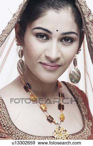 Portrait of a young woman in traditional clothing smiling View Large Photo Image Stock Photo - Portrait of a young woman in traditional clothing smiling. Fotosearch