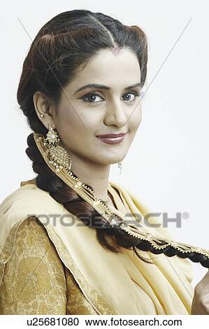 Side profile of a young woman smiling View Large Photo Image Stock Image - Side profile of a young woman smiling. Fotosearch