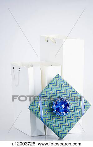 Stock Photograph - Close-up of a gift and paper bags. Fotosearch