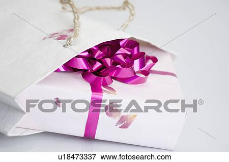 Close-up of a gift in a paper bag View Large Photo Image Stock Photo - Close-up of a gift in a paper bag. Fotosearch