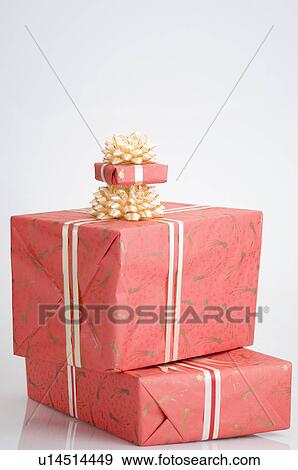 Stock Photo - Close-up of a stack of three gifts. Fotosearch