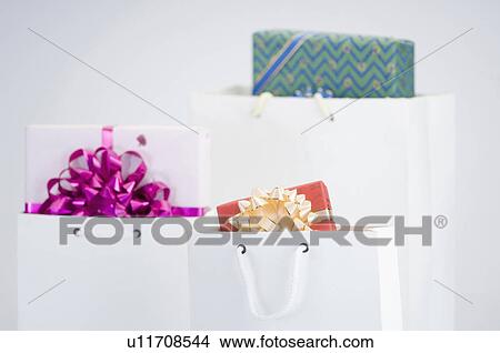 Close-up of gifts in three paper bags View Large Photo Image Picture - Close-up of gifts in three paper bags. Fotosearch