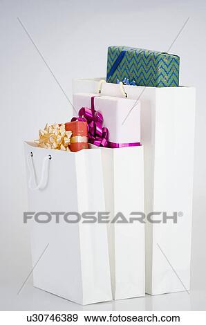 Close-up of gifts in three paper bags View Large Photo Image Stock Photo - Close-up of gifts in three paper bags. Fotosearch