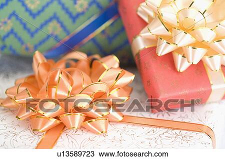 Close-up of three gifts View Large Photo Image Stock Image - Close-up of three gifts. Fotosearch