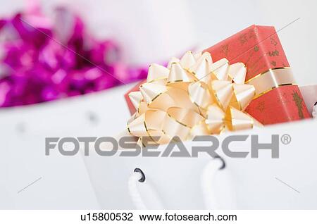 Close-up of two gifts in two paper bags View Large Photo Image Stock Image - Close-up of two gifts in two paper bags. Fotosearch