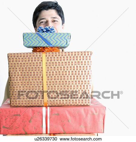 Portrait of a boy holding a stack of gifts View Large Photo Image Stock Image - Portrait of a boy holding a stack of gifts. Fotosearch