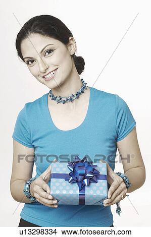 Picture - Portrait of a young woman holding a gift. Fotosearch