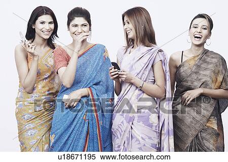 Close-up of four young women holding mobile phones View Large Photo Image Stock Photography - Close-up of four young women holding mobile phones. Fotosearch