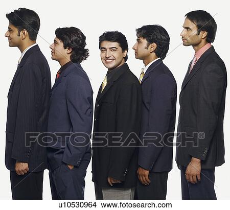 Portrait of a businessman standing in a row with his colleagues View Large Photo Image Picture - Portrait of a businessman standing in a row with his colleagues. Fotosearch