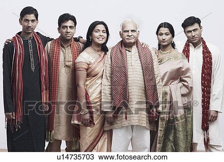 Stock Image - Portrait of a mature couple and their children smiling. Fotosearch