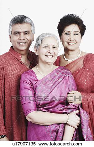 Stock Photography - Portrait of a mature woman standing with a mature couple. Fotosearch