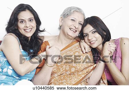 Stock Photography - Portrait of a mother and her two daughters holding hands. Fotosearch