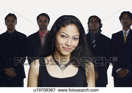 Portrait of a young woman smiling with four businessmen standing behind her View Large Photo Image Stock Photo - Portrait of a young woman smiling with four businessmen standing behind her. Fotosearch