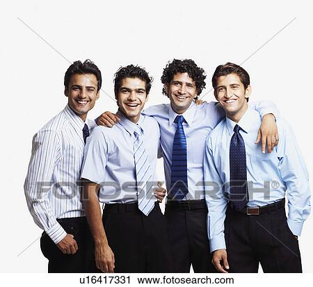 Stock Image - Portrait of four businessmen standing together and smiling. Fotosearch
