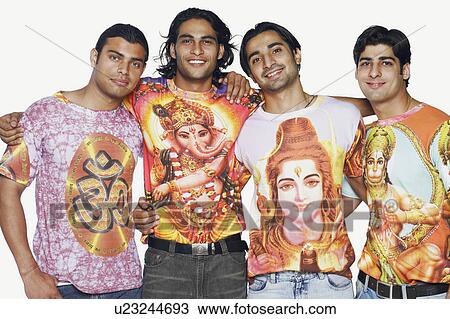 Stock Image - Portrait of four young men standing together and smiling. Fotosearch