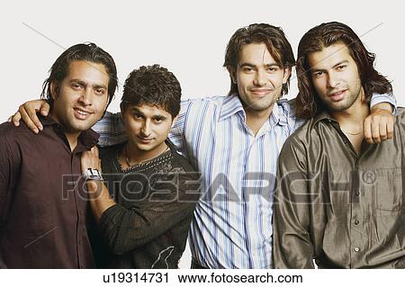 Stock Image - Portrait of four young men with their arms around each other. Fotosearch