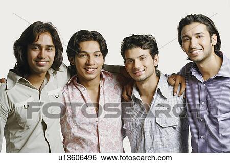 Portrait of four young men with their arms around each other and smiling View Large Photo Image Stock Photograph - Portrait of four young men with their arms around each other and smiling. Fotosearch