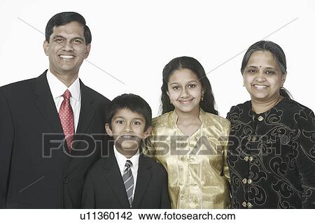 Stock Image - Portrait of parents standing with their son and daughter. Fotosearch