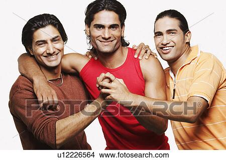 Picture - Portrait of three young men holding hands and smiling. Fotosearch