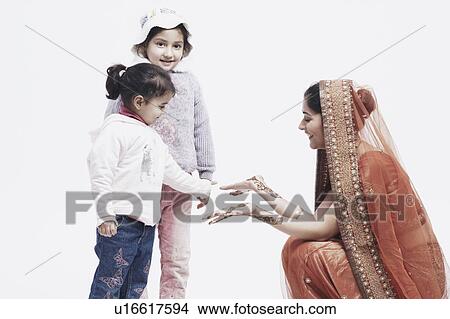 Bride showing her hands to two girls View Large Photo Image Picture - Bride showing her hands to two girls. Fotosearch
