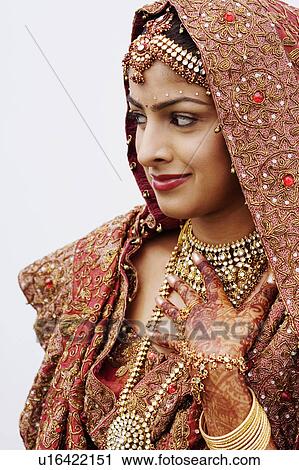 Stock Image - Close-up of a bride in a traditional wedding dress. Fotosearch