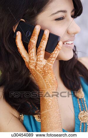 Stock Photo - Close-up of a young woman talking on a mobile phone. Fotosearch