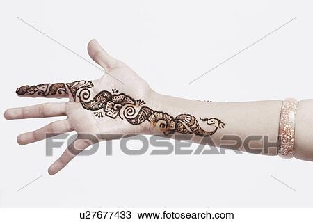 Stock Image - Close-up of a young woman with henna tattoo's on her hand. Fotosearch