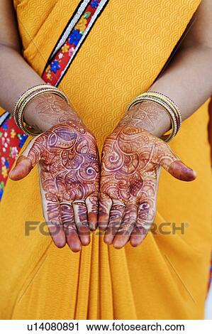 Mid section view of a woman showing her henna tattooed hands View Large Photo Image Stock Image - Mid section view of a woman showing her henna tattooed hands. Fotosearch