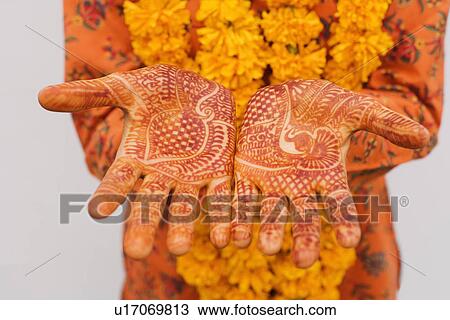 Mid section view of a woman showing her henna tattooed hands View Large Photo Image Stock Image - Mid section view of a woman showing her henna tattooed hands. Fotosearch